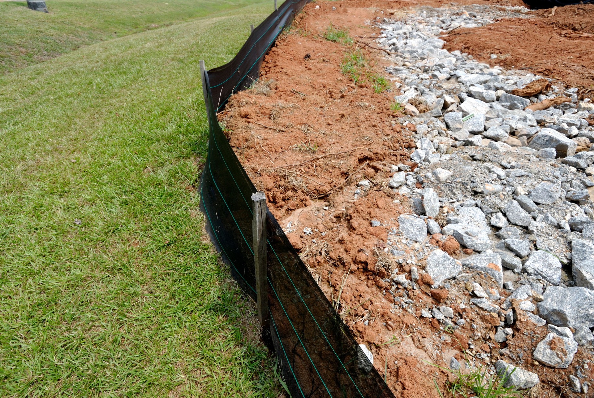 Silt fence erosion control barrier at construction site